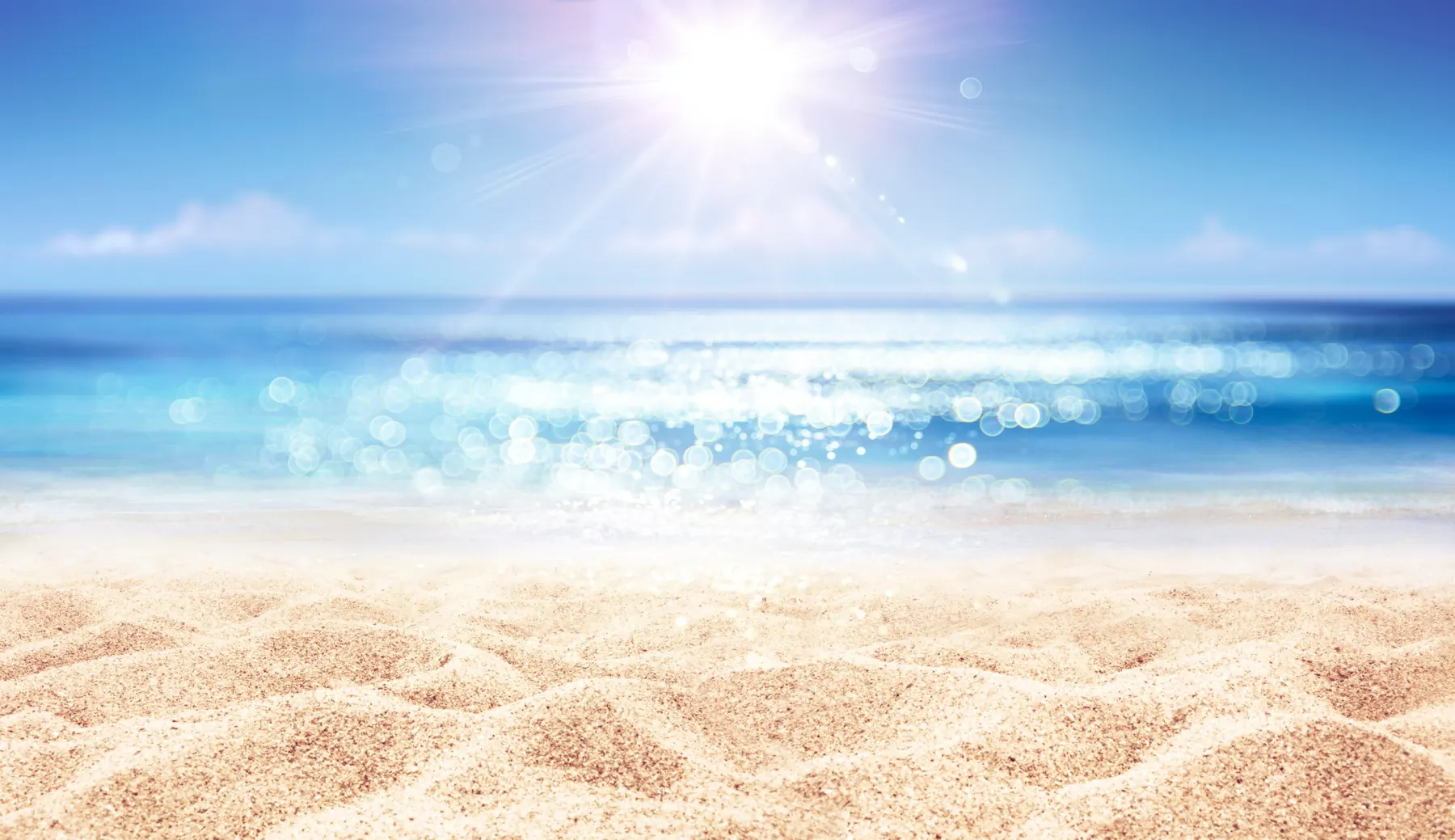 strand en water, terwijl de zon erop schijnt